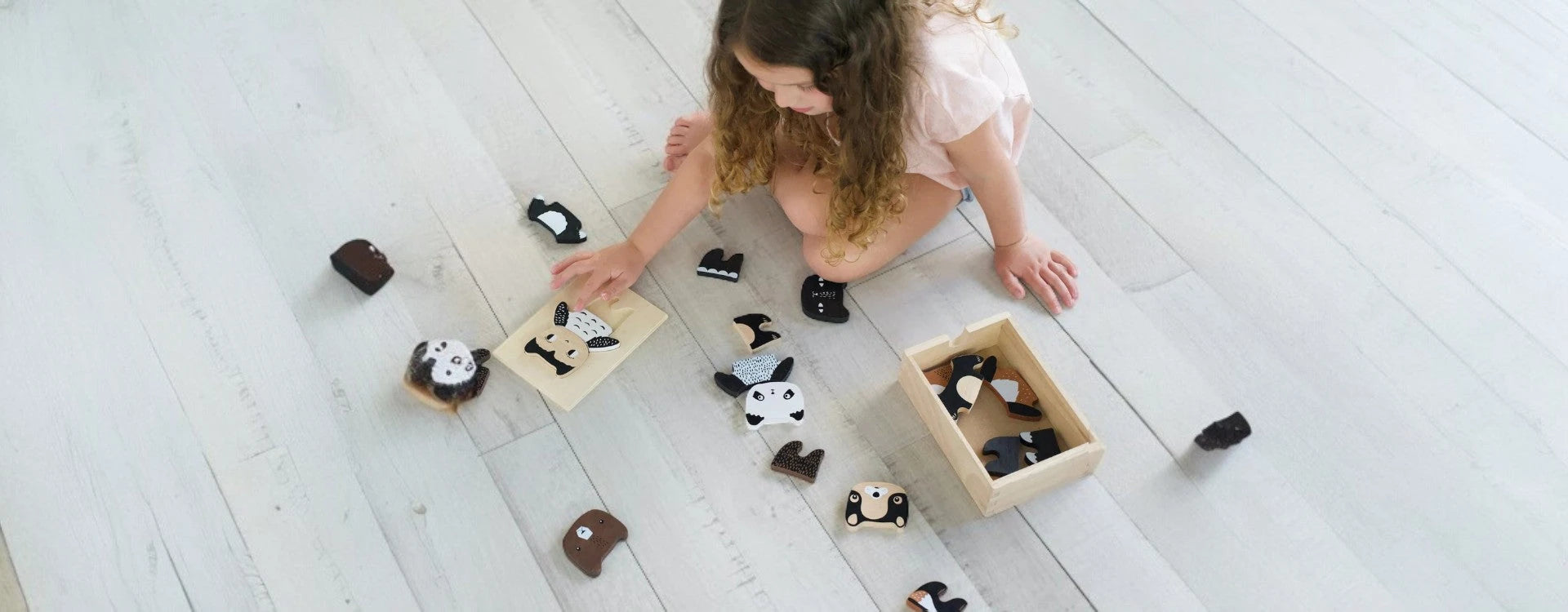 Child playing with wooden toys