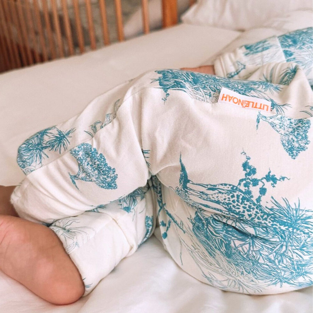 Baby wearing Little Noah Bamboo Safari Sleepsuit in Blue