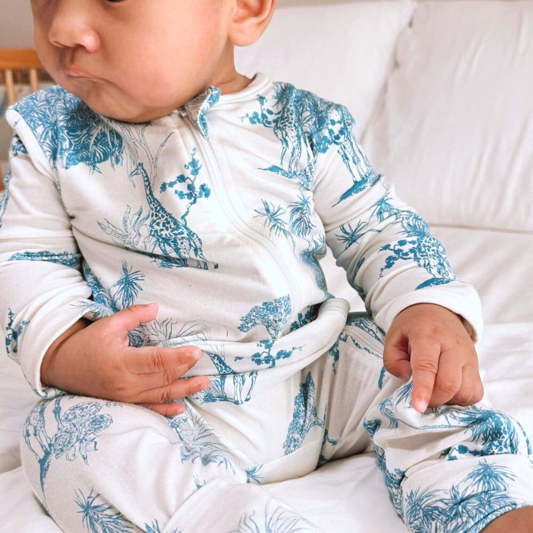 Baby wearing Little Noah Bamboo Safari Sleepsuit in Blue