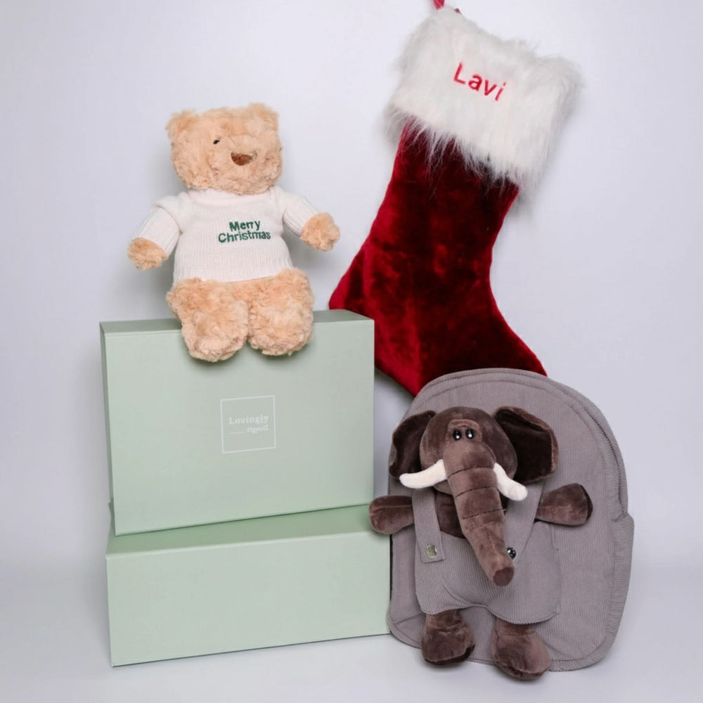 Christmas Themed Gift Hamper consisting of 4 products - Hugsy Teddy, red stocking, elephant backpack and soy candle