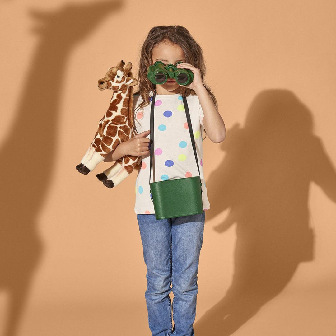 Child holding her Living Nature Giraffe Plush Toy