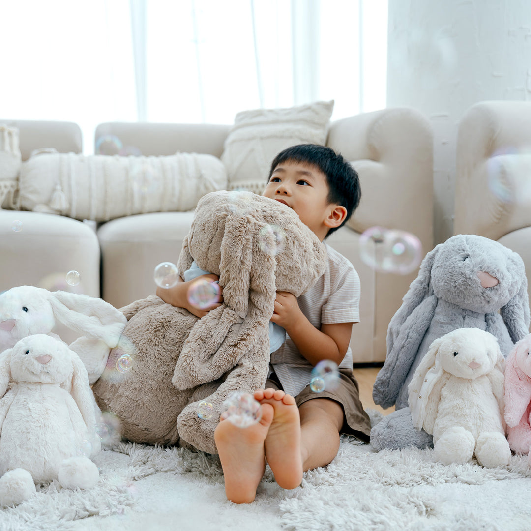 Boy with many Jellycat Bunnies