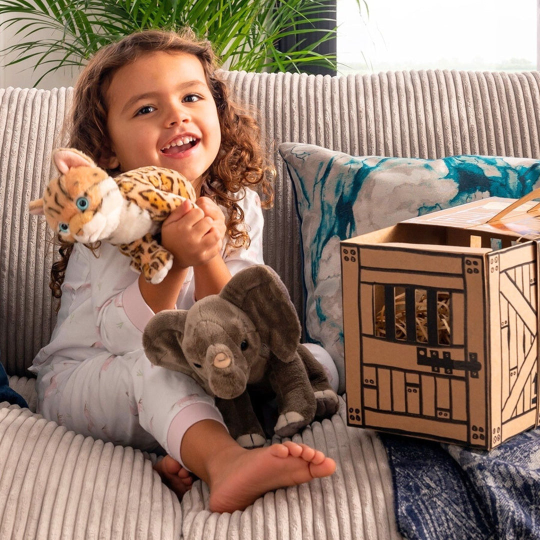 Little Girl playing with Living Nature Cheetah and Elephant Soft Toy