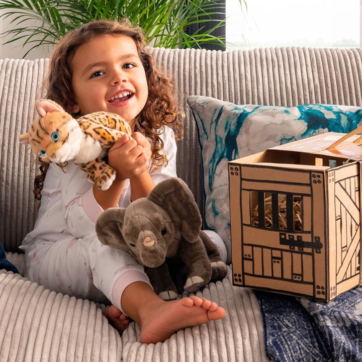 Little Girl playing with Living Nature Cheetah and Elephant Soft Toy