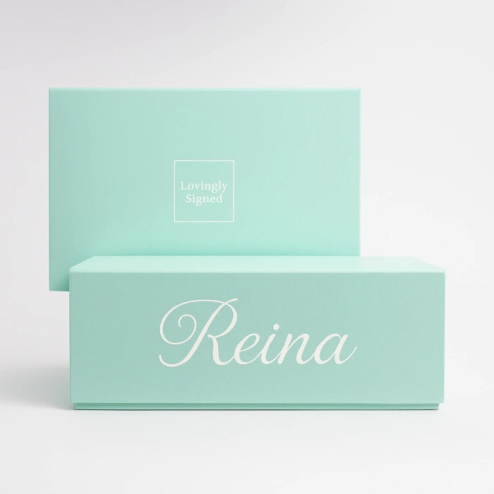 Two silky green boxes personalised with 'Reina' and 'Lovingly Signed' text on a white background