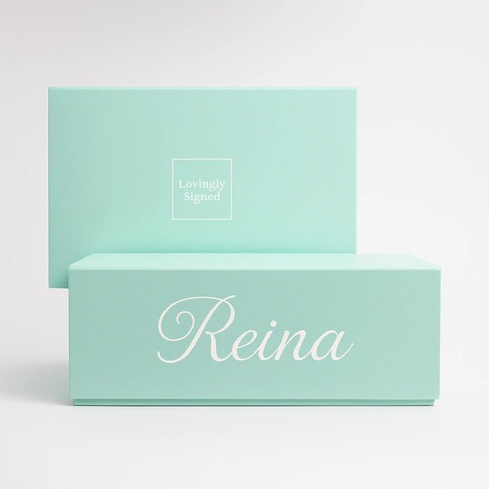Two silky green boxes personalised with 'Reina' and 'Lovingly Signed' text on a white background