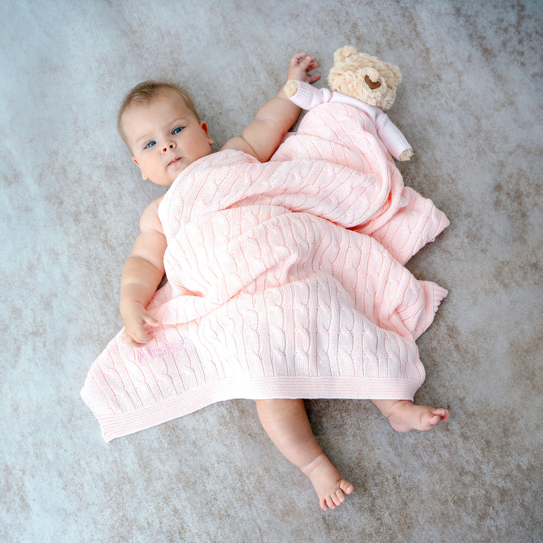 Baby and Hugsy Teddy covered with Pink Cable Knit Blanket