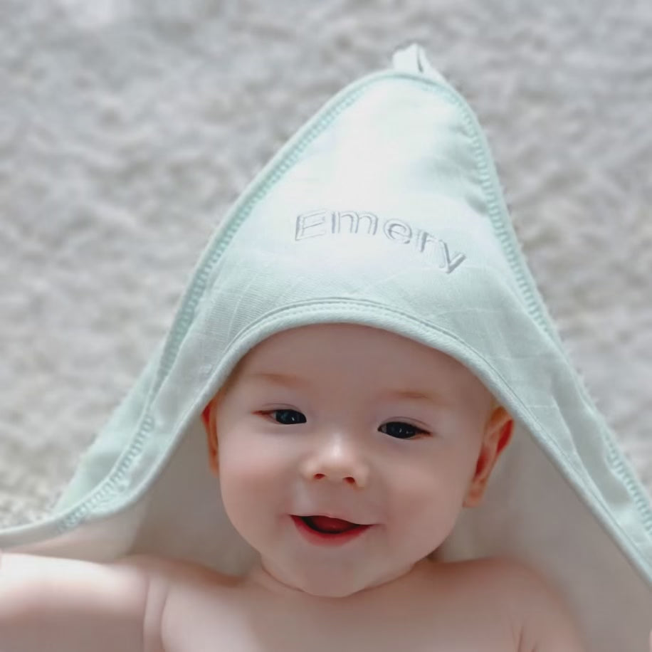 Baby using the Personalised Green Hooded Towel