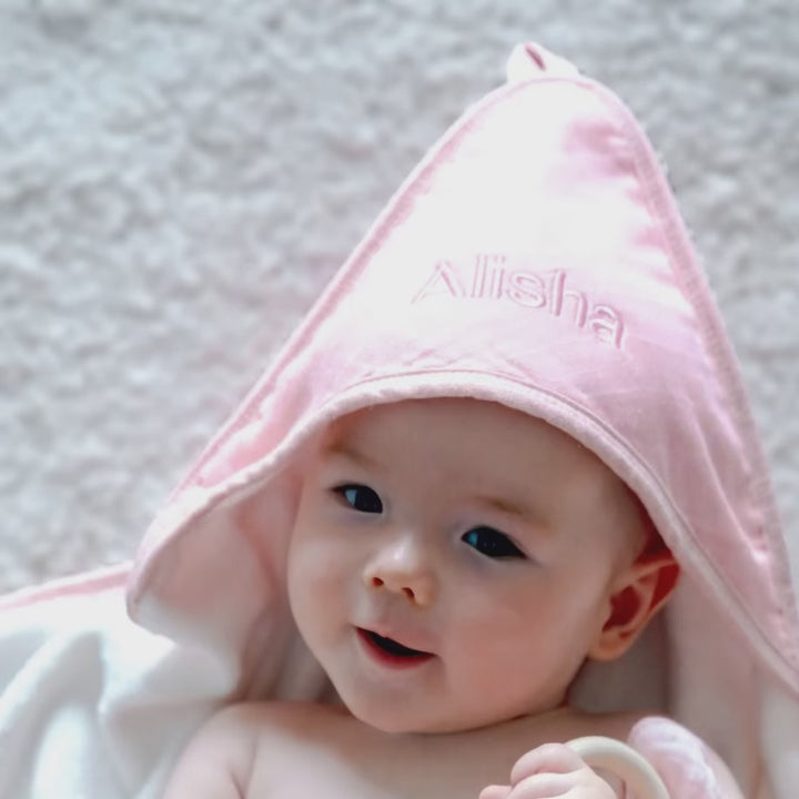 Baby using the Personalised Pink Hooded Towel