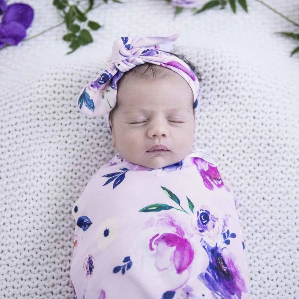 Soft newborn swaddle with matching floral topknot