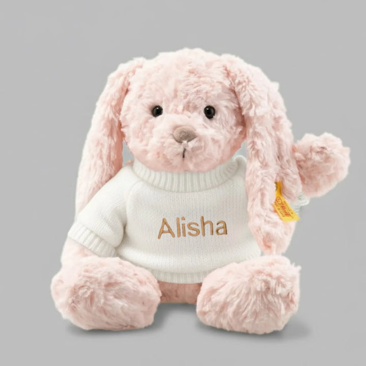 Pink plush bunny wearing a white sweater with 'Alisha' personalised