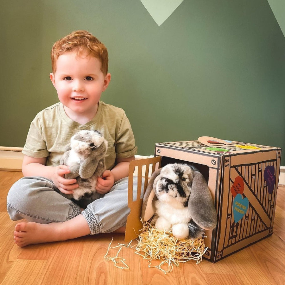 Boy playing with his Living Nature Rabbit Plush Toys