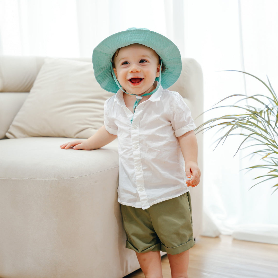 Toddler wearing green sun hat
