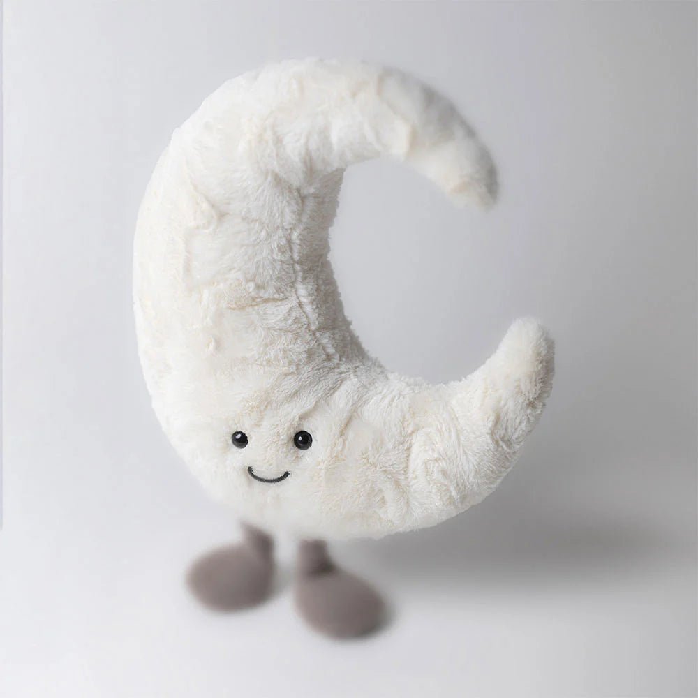 Jellycat Soft toy shaped like a crescent moon with a smiling face on a white background