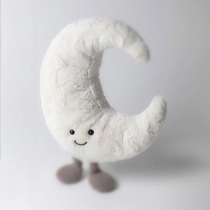 Jellycat Soft toy shaped like a crescent moon with a smiling face on a white background