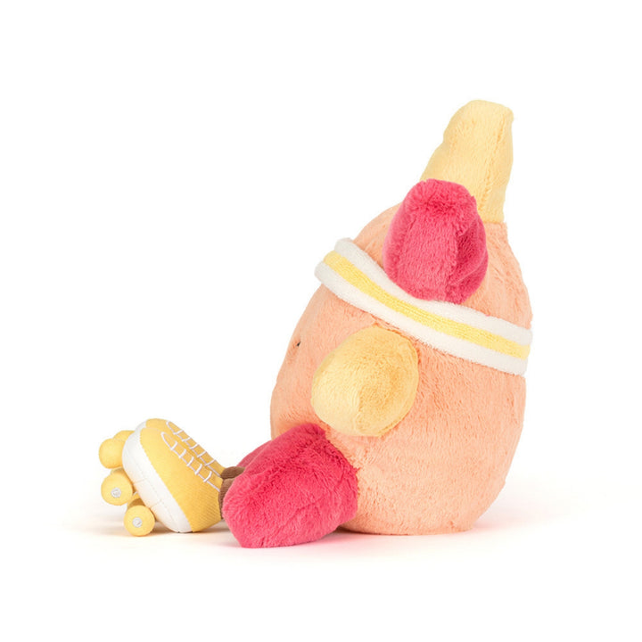 Peach and yellow roller-skating sun soft toy shown from the side, featuring a white and yellow sweatband, bright pink limbs and yellow roller skates.