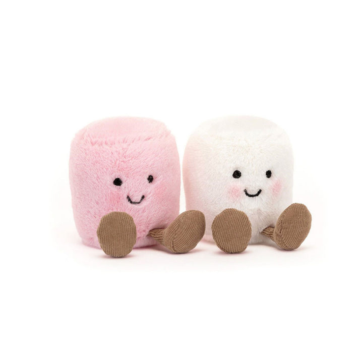 Pink and white marshmallow soft toy pair sitting side by side, each with a smiling embroidered face, rosy cheeks and brown corduroy legs.