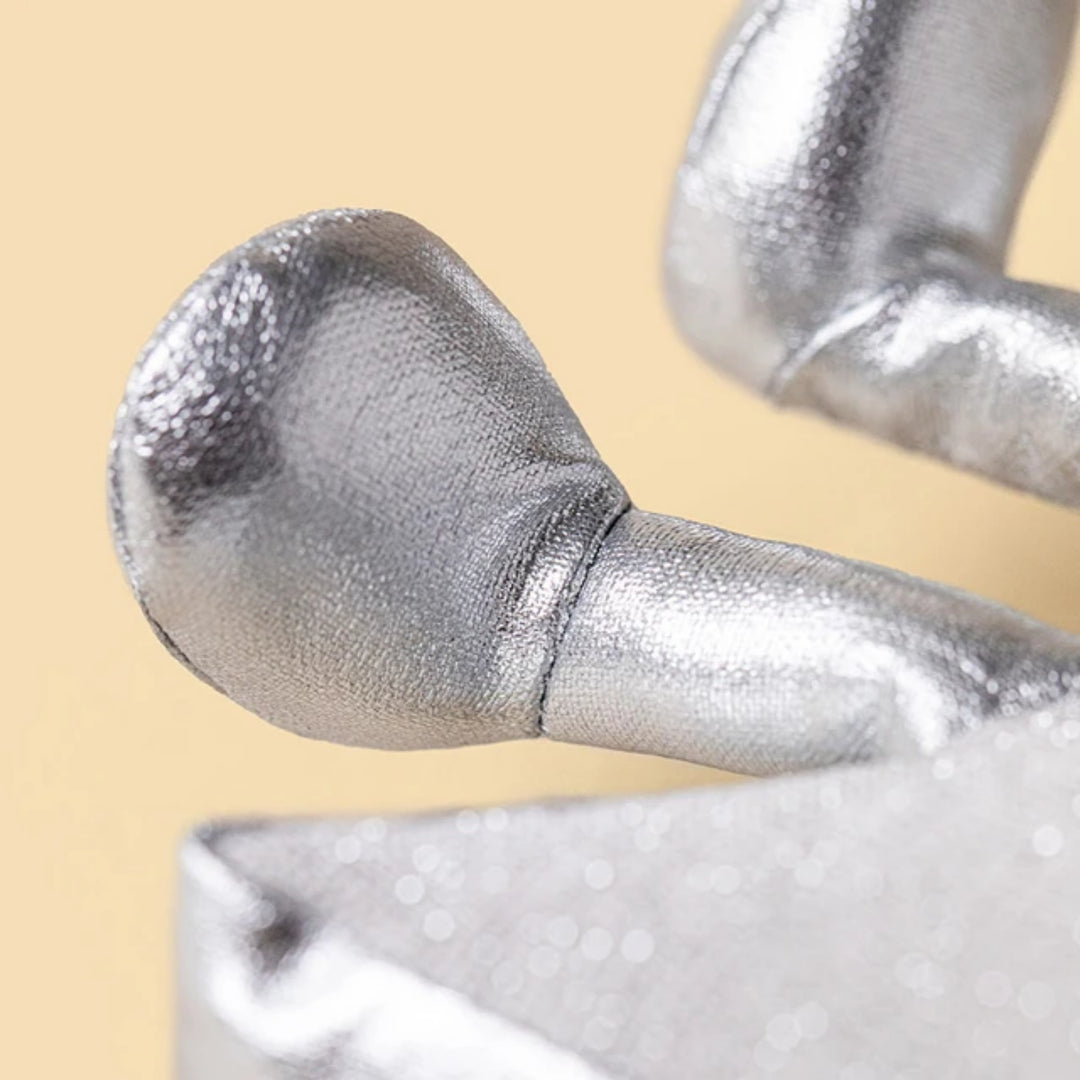 Close-up of the Jellycat Amuseables Silver Star's metallic silver foot, showing its shiny fabric texture and stitching details.