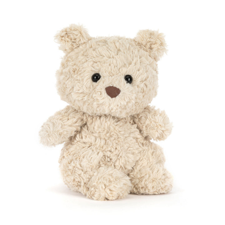 Cream Bartholomew Bear Junior soft toy sitting upright, with fluffy textured fur, round ears, glossy black eyes and a soft brown nose.