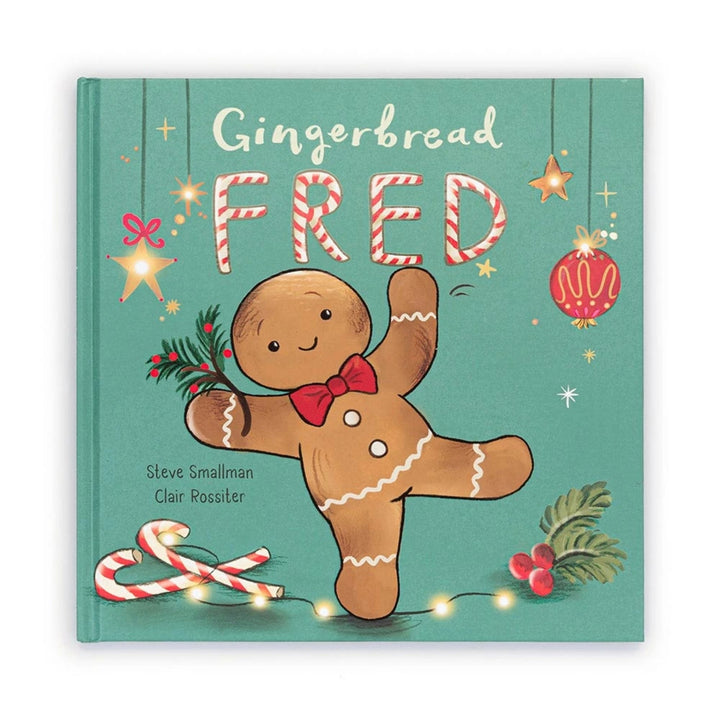 Jellycat “Gingerbread Fred” children’s Christmas picture book with a teal cover featuring a smiling gingerbread man, candy canes, holly and festive lights.