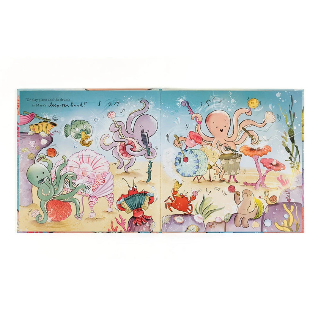 Open “Odell’s Amazing Arms” picture book showing a colourful underwater scene with octopuses and sea creatures playing musical instruments.