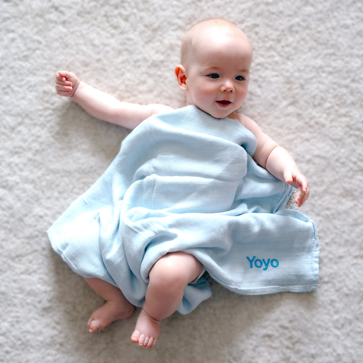 baby covered in Blue Swaddle towel