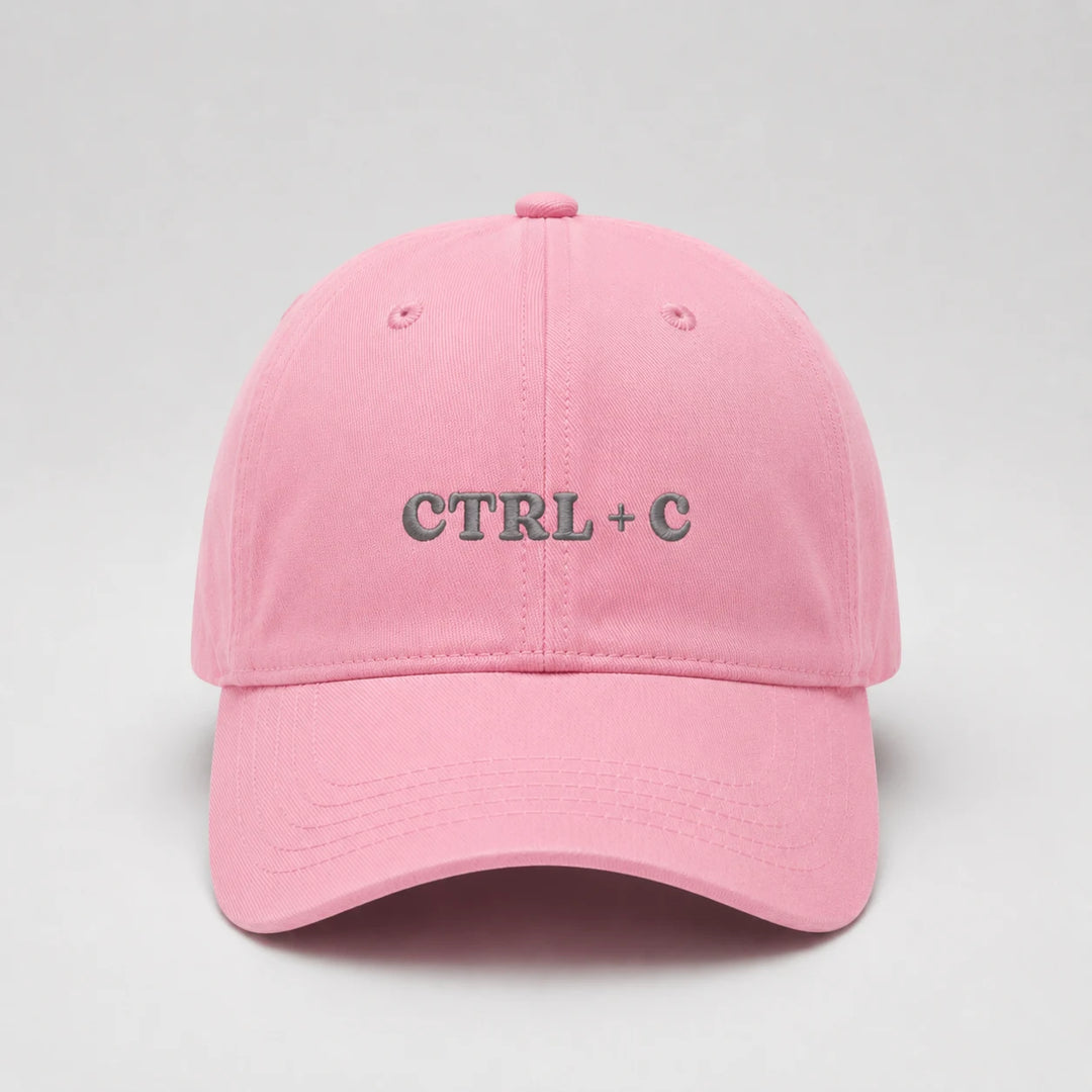 Pink cap with 'CTRL + C' text on a light gray background