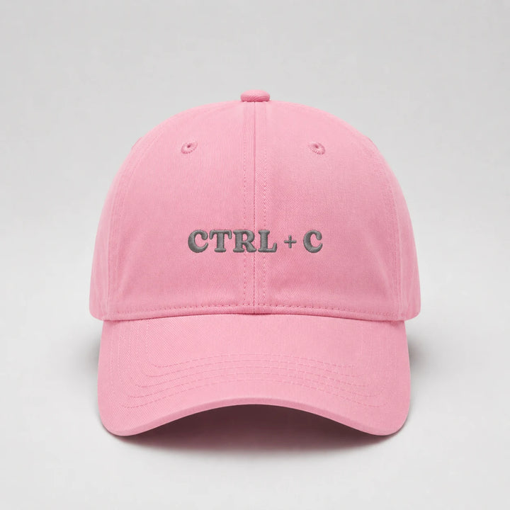 Pink cap with 'CTRL + C' text on a light gray background
