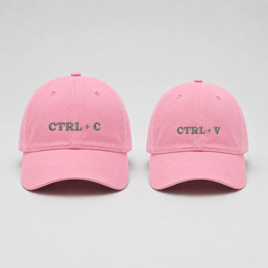 Two pink caps with 'CTRL + C' and 'CTRL + V' text on a light gray background
