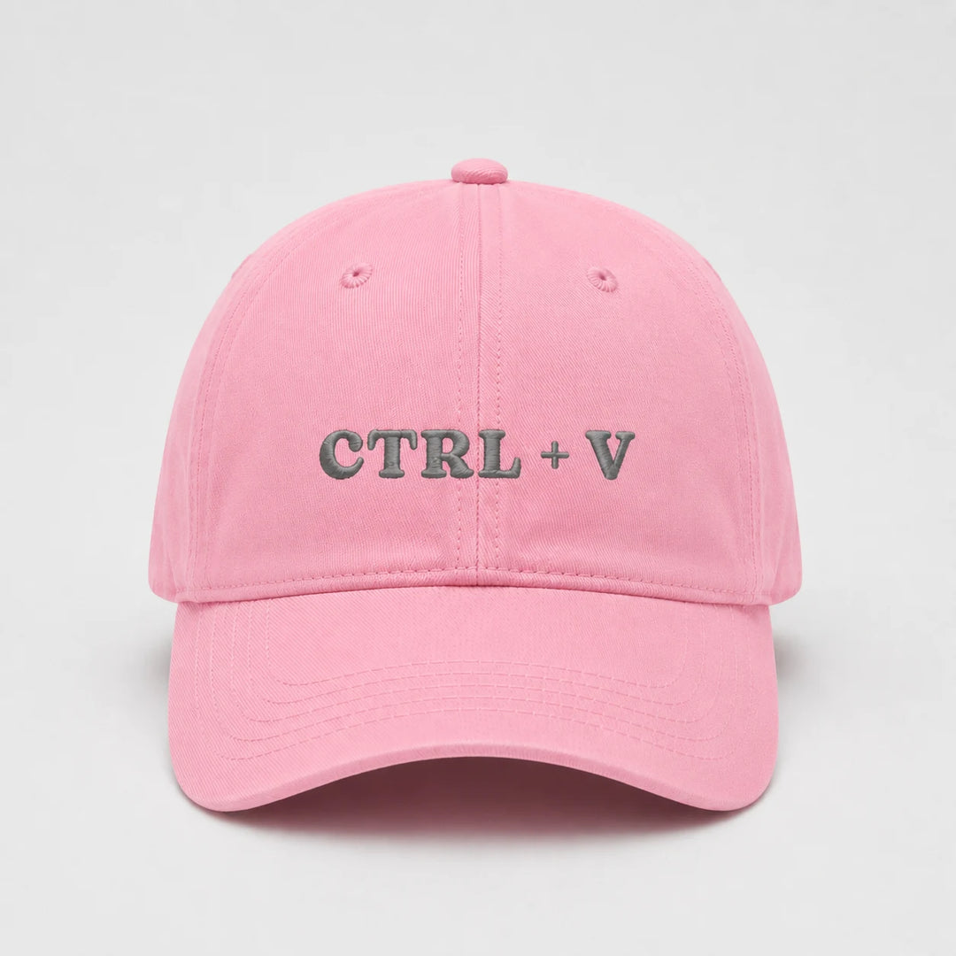 Pink cap with 'CTRL + V' text on a light gray background