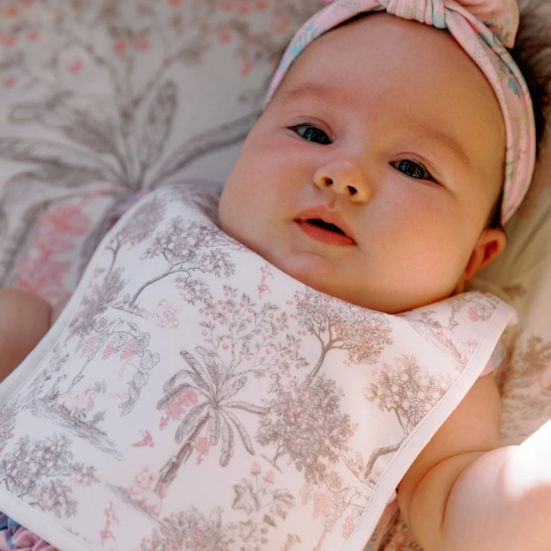 Baby wearing House of Holly Reversible Bamboo Baby Bib with Toile de Jouy Garden Print