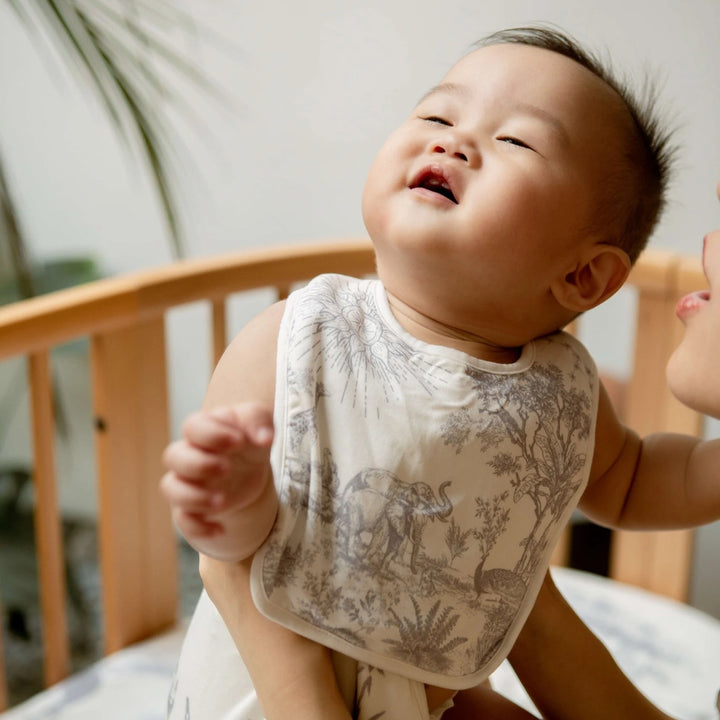 Toddler-friendly reversible bib with absorbent terry backing