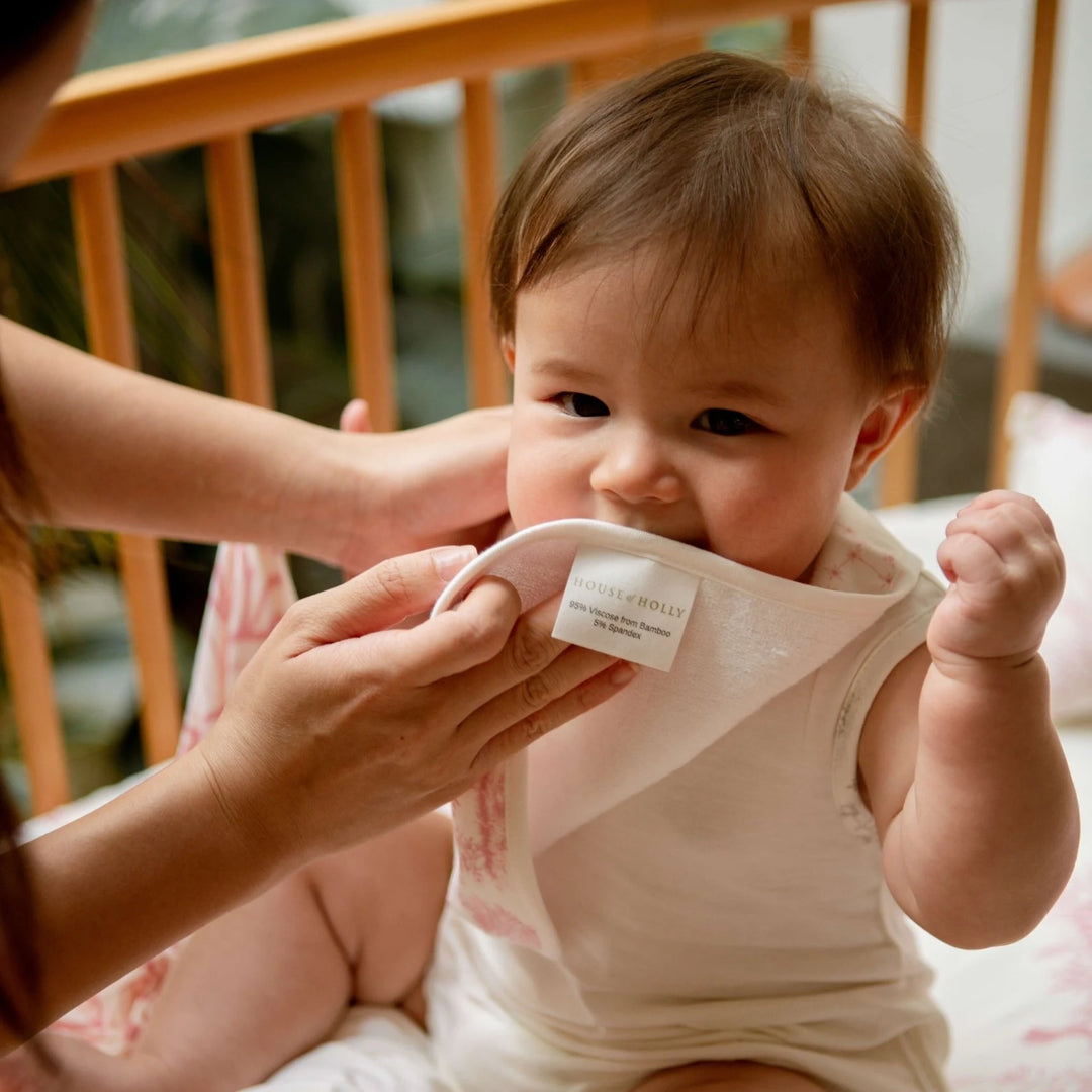 Toddler-friendly reversible bib with absorbent terry backing