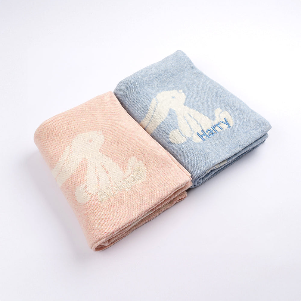 Two folded baby blankets with bunny designs