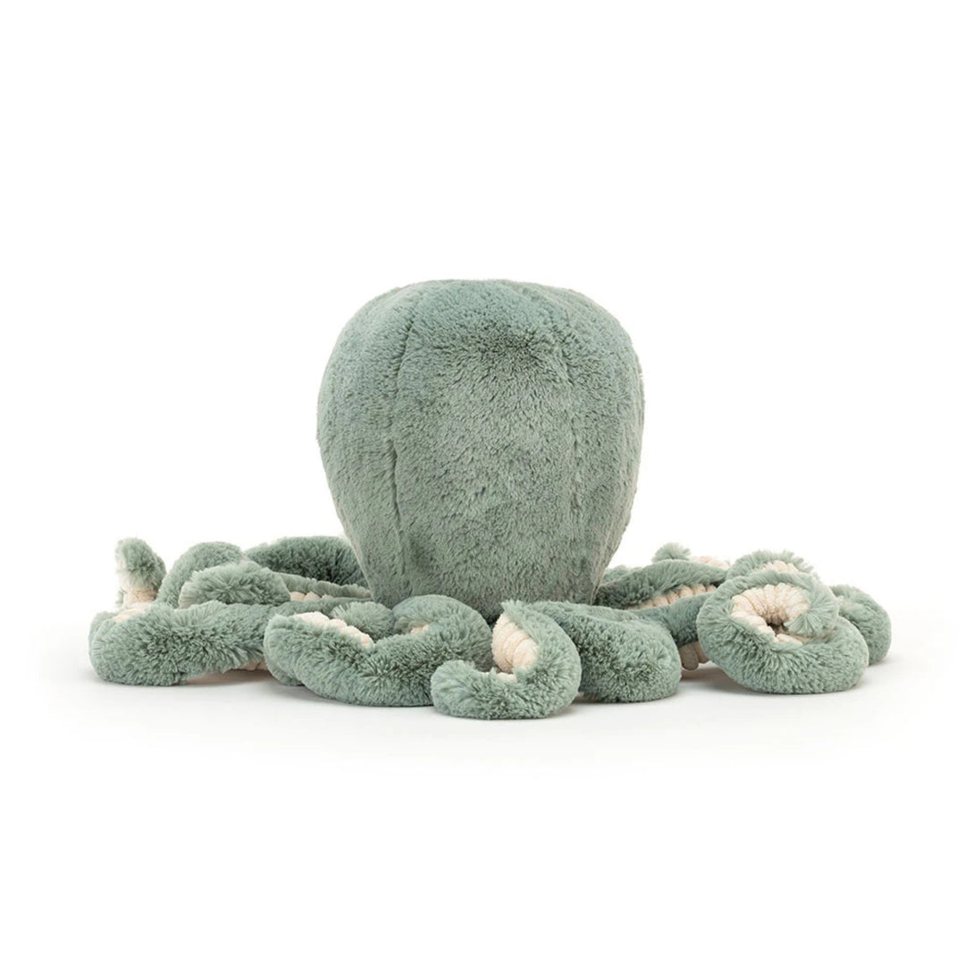 Sage green octopus soft toy shown from the back, featuring a rounded plush head and multiple curled tentacles with contrasting cream corduroy undersides.