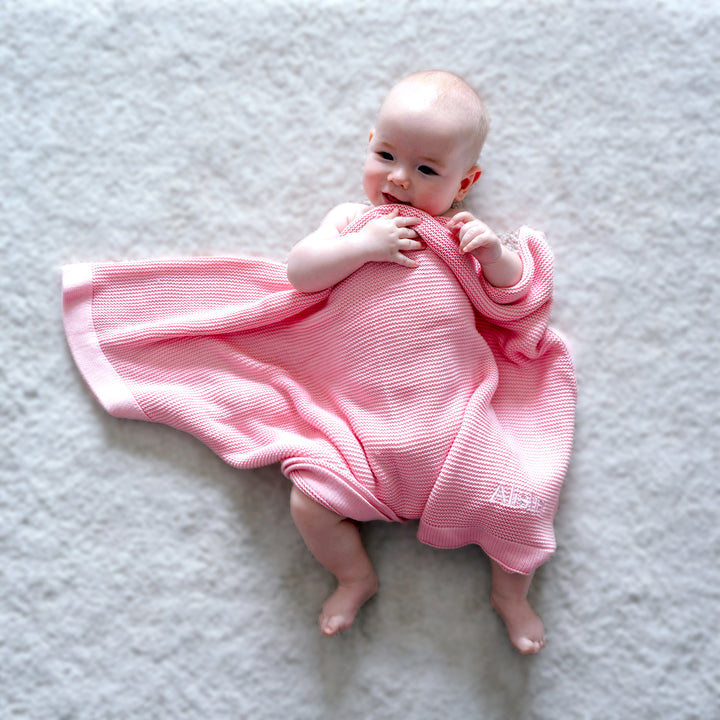 baby covered in Pink Bamboo Blanket 