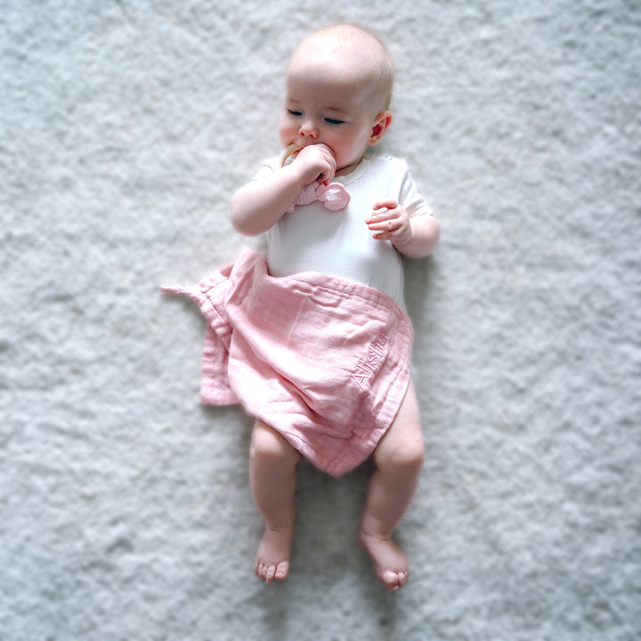 Pink muslin washcloth for gentle care
