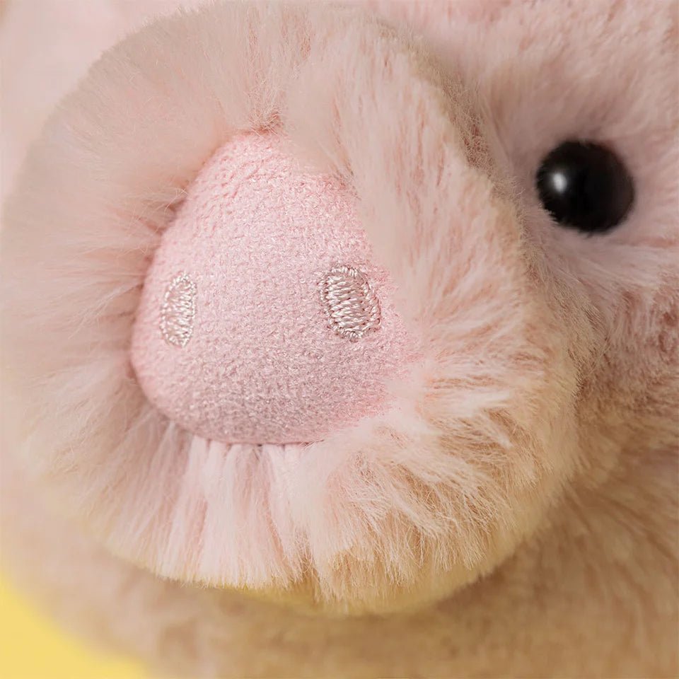 Close up of Jellycat Smudge Pig cuddly stuffed animal in pastel pink