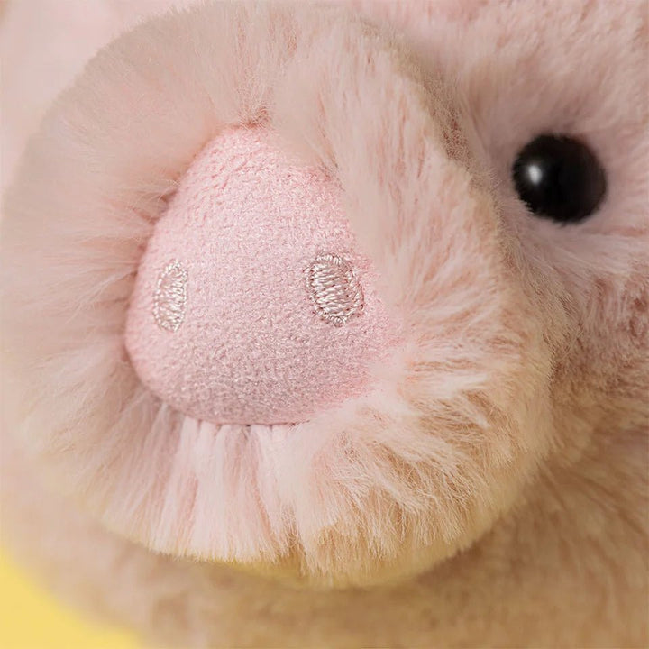 Close up of Jellycat Smudge Pig cuddly stuffed animal in pastel pink
