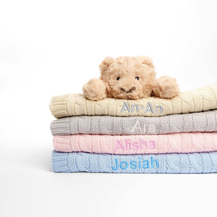 Premium personalized cable knit baby blanket. Choose from pink, grey, cream, and blue to create the perfect bedding