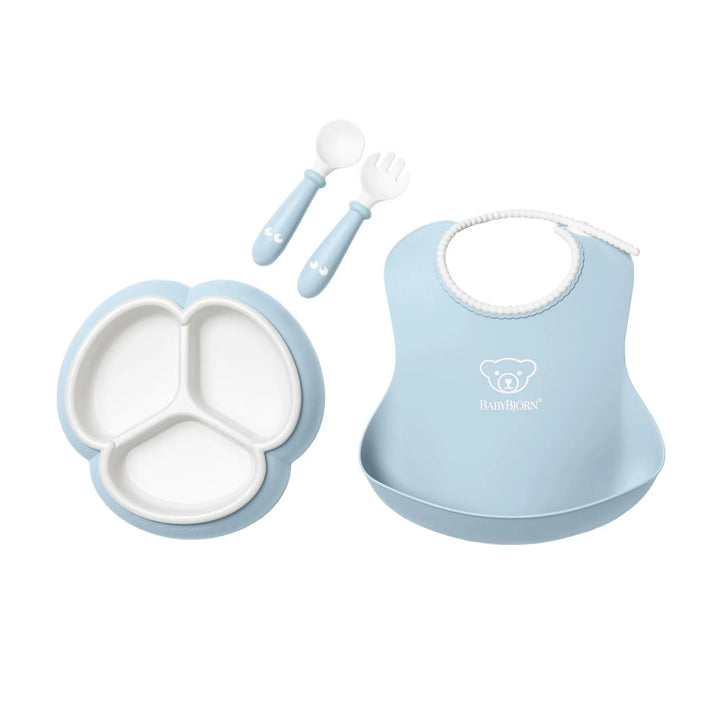 BabyBjörn Blue mealtime set with spoon, fork, cup, and divided plate.