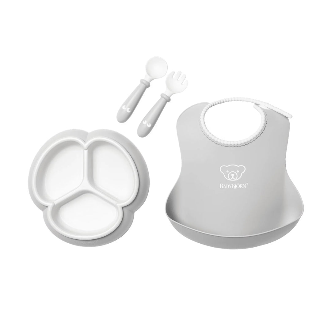 BabyBjörn feeding set with plate, bowl, spoon, and cup in soft grey colour.
