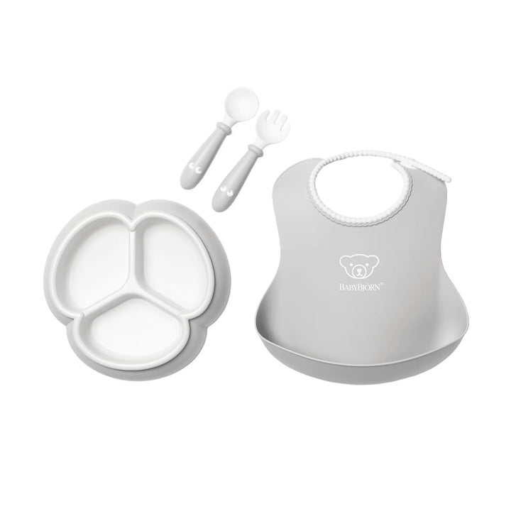 BabyBjörn feeding set with plate, bowl, spoon, and cup in soft grey colour.