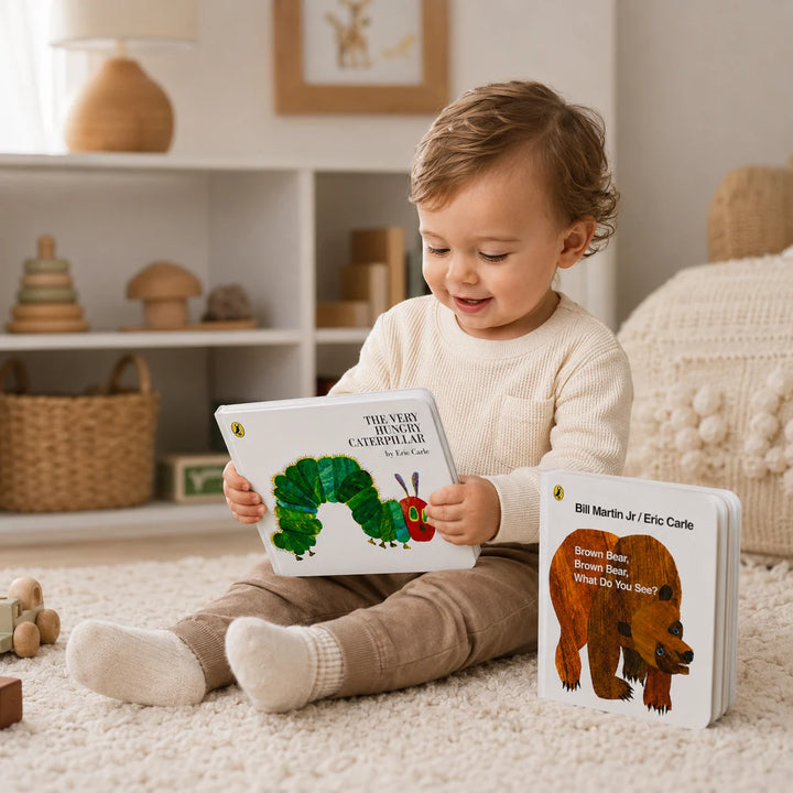 Child holding a book with a caterpillar and bear bookin a cosy room.