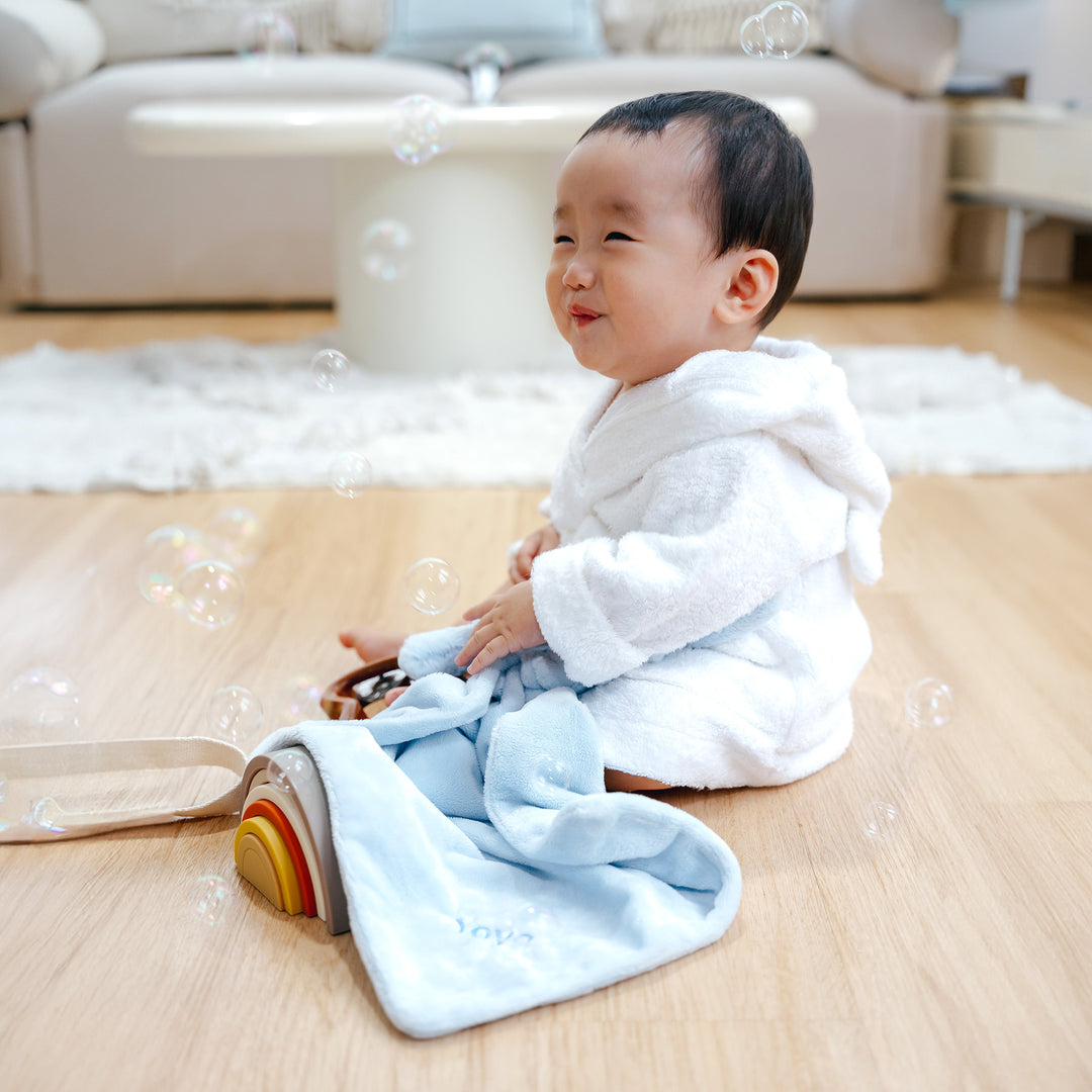 Baby playing with Jellycat Bashful Blue Bunny Soother