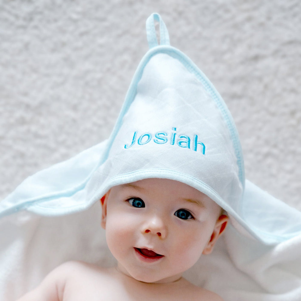 baby wearing a blue coloured towel 
