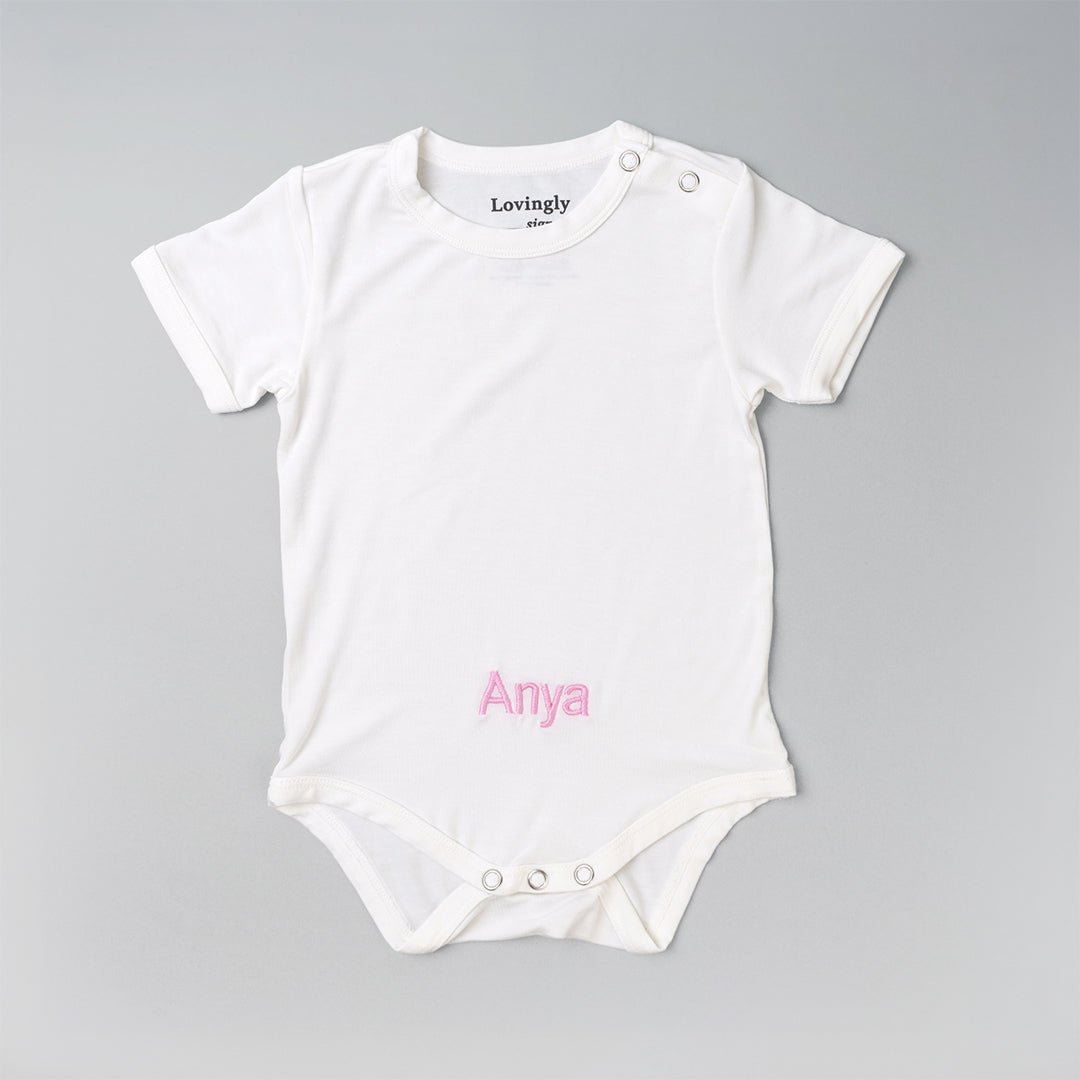 Personalised White Baby Clothing with "Anya" in Pink Thread