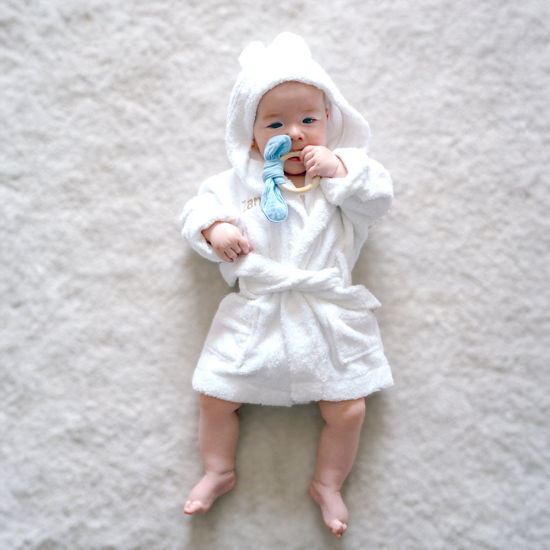 Baby in White Bamboo Bathrobe and Blue teether