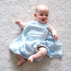 Baby wrapped in a blue bamboo swaddle with 'Yoyo' personalised