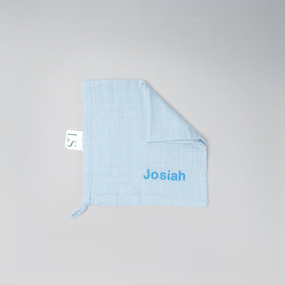 Blue muslin washcloth with 'Josiah' embroidered in blue thread